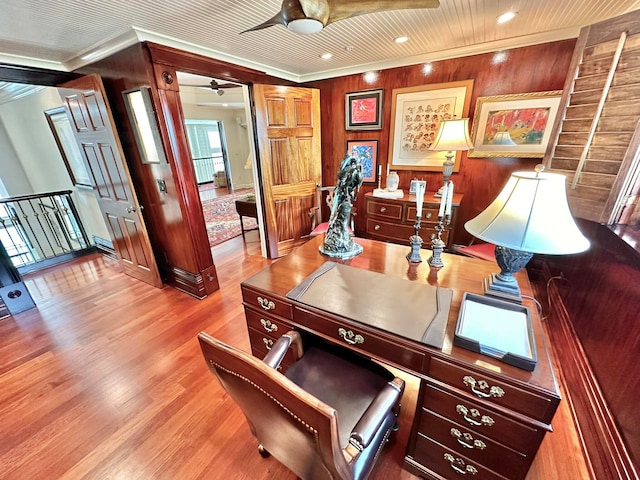 office space featuring ornamental molding, wood walls, hardwood / wood-style floors, and ceiling fan