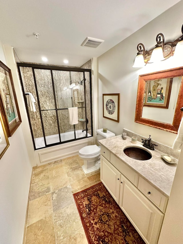 full bathroom featuring toilet, bath / shower combo with glass door, and vanity