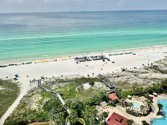 bird's eye view with a water view and a beach view