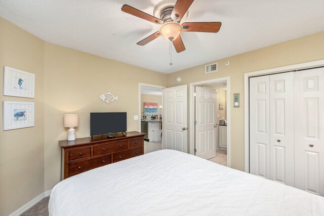 bedroom with ceiling fan, light carpet, and a closet