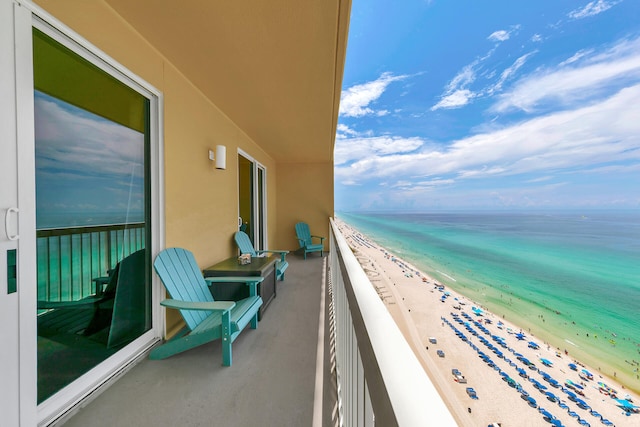 balcony with a water view and a beach view