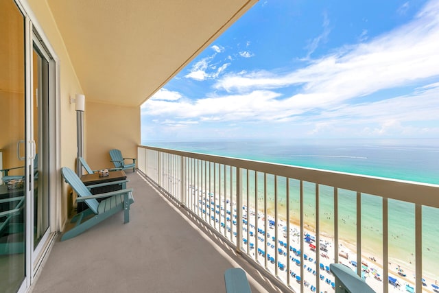 balcony with a view of the beach and a water view