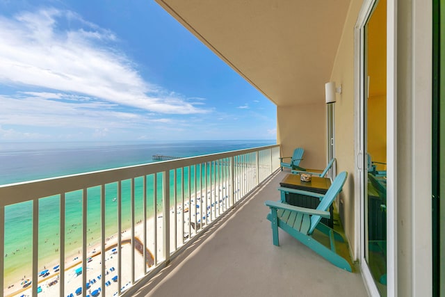 balcony with a water view and a beach view