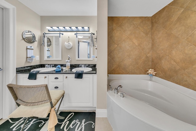 bathroom featuring a washtub and vanity