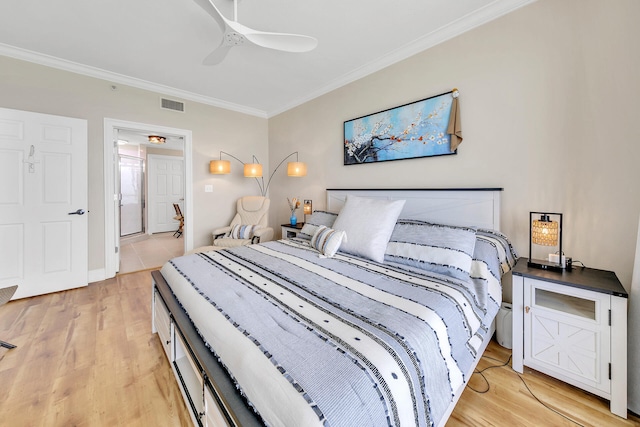 bedroom with light hardwood / wood-style flooring, ornamental molding, and ceiling fan