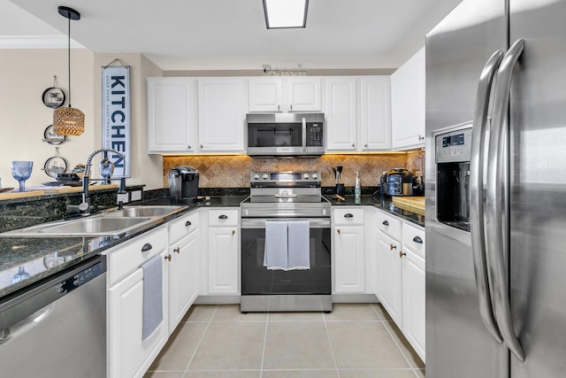 kitchen featuring pendant lighting, white cabinetry, stainless steel appliances, and sink