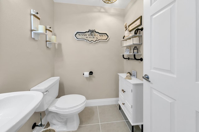 bathroom with sink, tile patterned floors, and toilet