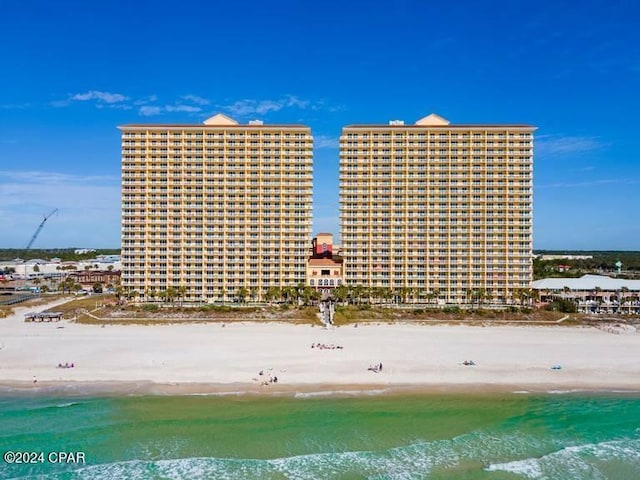 exterior space featuring a water view and a beach view