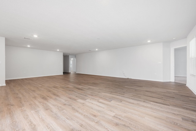 basement with light hardwood / wood-style floors