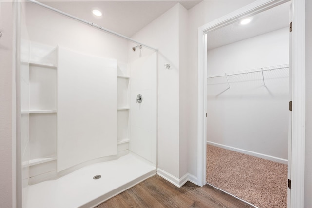 bathroom with hardwood / wood-style floors and a shower