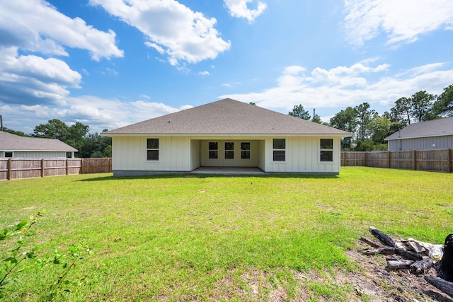 rear view of house with a patio area and a lawn