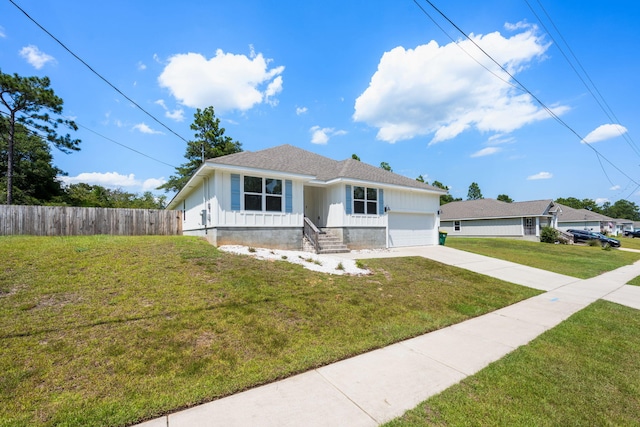 view of front of property featuring a front yard and a garage