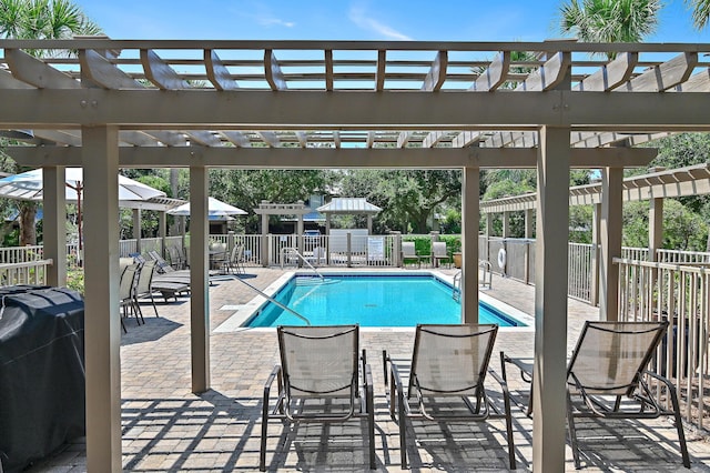 pool with a patio area, fence, grilling area, and a pergola