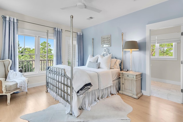 bedroom with visible vents, baseboards, and multiple windows