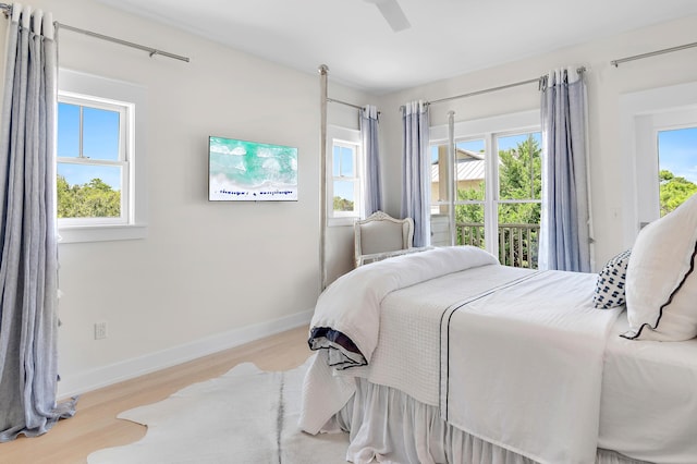 bedroom with a ceiling fan, baseboards, and wood finished floors