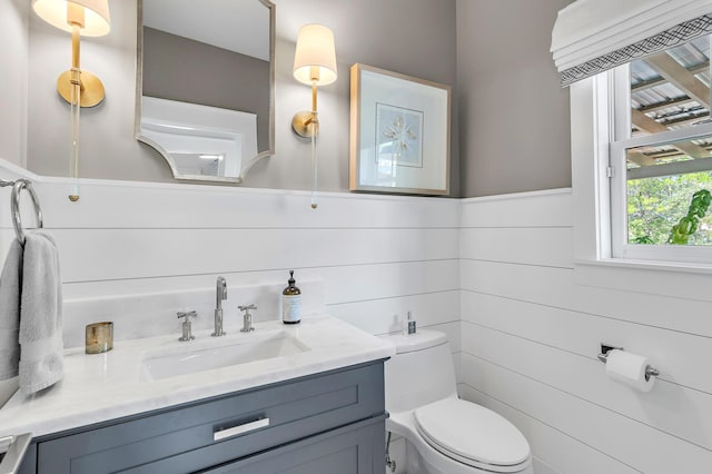 half bathroom with vanity and toilet