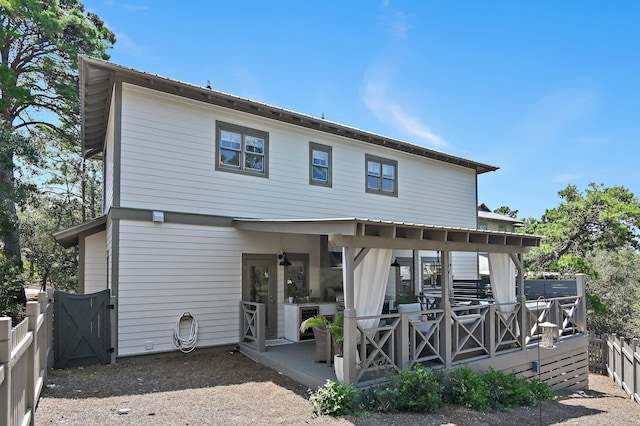 rear view of property with a fenced backyard