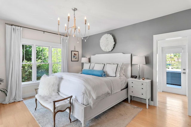 bedroom featuring a chandelier and light wood-type flooring