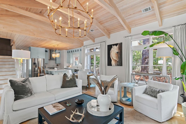 living area featuring visible vents, lofted ceiling with beams, wood ceiling, stairway, and a chandelier