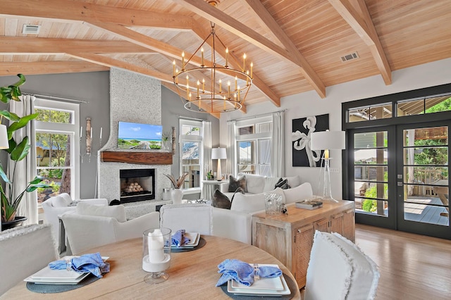 living area featuring wooden ceiling, a fireplace, wood finished floors, visible vents, and french doors