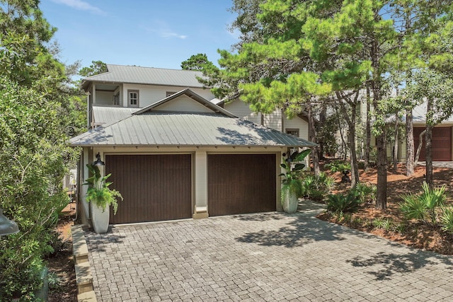 garage with decorative driveway