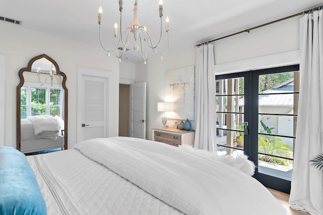 bedroom with visible vents and an inviting chandelier