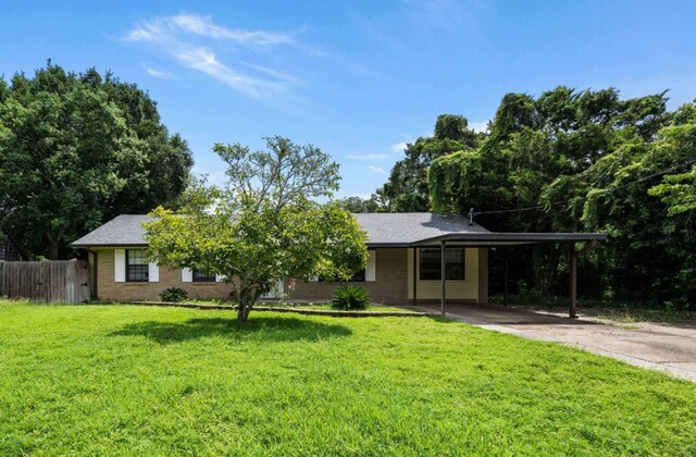 view of front facade with a carport and a front lawn