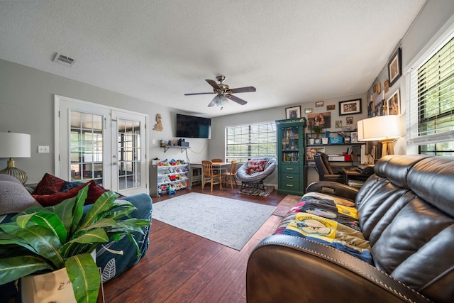 living room featuring wood-type flooring, a textured ceiling, french doors, and ceiling fan