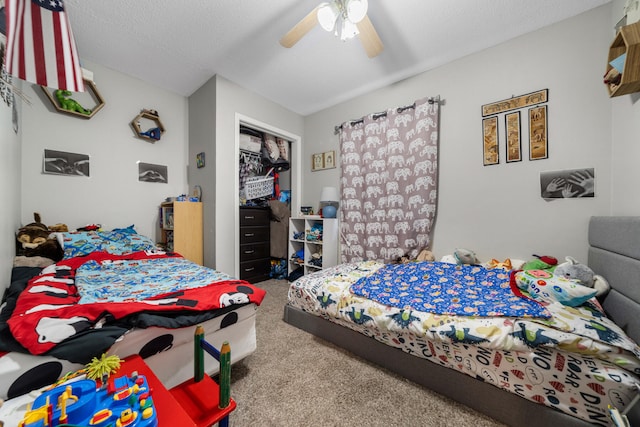 bedroom featuring a closet, a textured ceiling, ceiling fan, and carpet floors