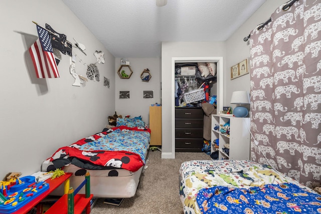 carpeted bedroom with a closet and a textured ceiling