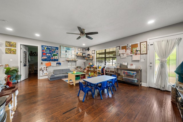 dining space featuring hardwood / wood-style flooring, a textured ceiling, and ceiling fan