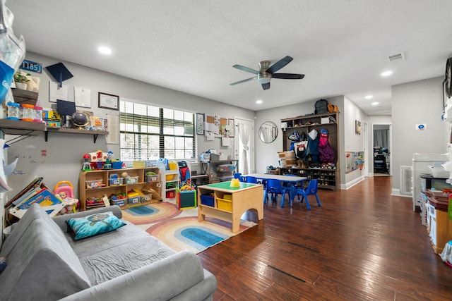 living room featuring wood-type flooring, a textured ceiling, and ceiling fan