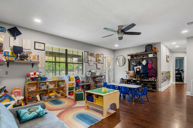 rec room featuring a textured ceiling, ceiling fan, and hardwood / wood-style floors