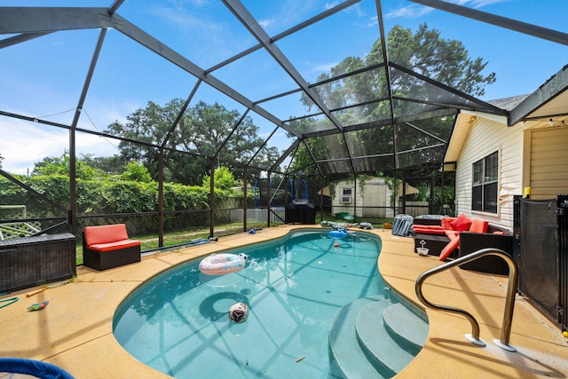 view of swimming pool with a storage unit, glass enclosure, and a patio