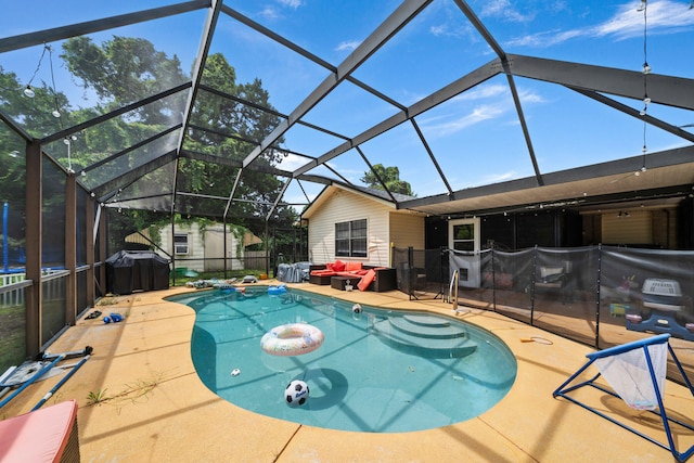 view of swimming pool featuring a patio area and a lanai