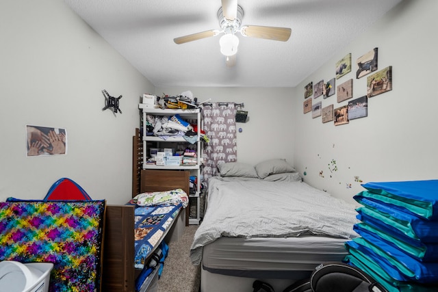 bedroom featuring a textured ceiling, ceiling fan, and carpet flooring