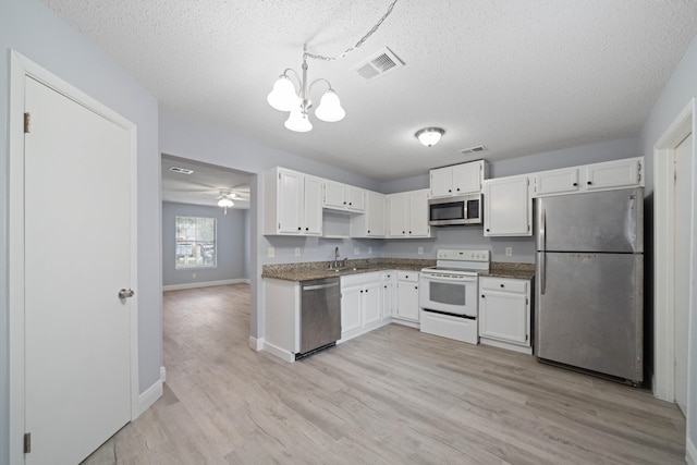 kitchen featuring white cabinetry, a textured ceiling, ceiling fan with notable chandelier, light hardwood / wood-style floors, and appliances with stainless steel finishes