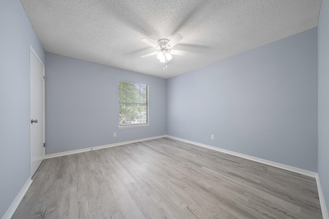 spare room with a textured ceiling, ceiling fan, and light wood-type flooring