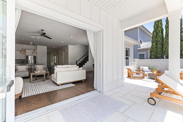 living room featuring ceiling fan and hardwood / wood-style flooring