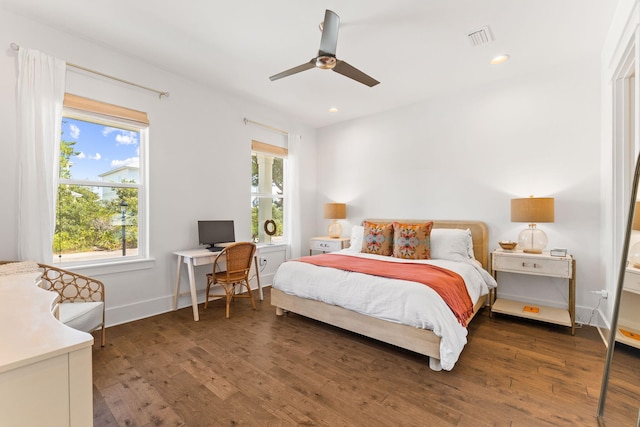 bedroom with dark hardwood / wood-style flooring and ceiling fan