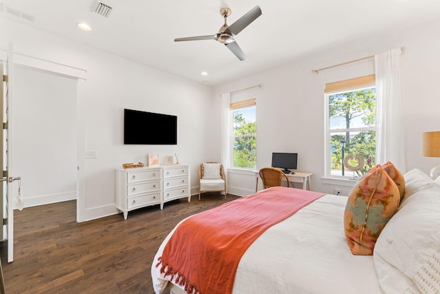 bedroom with dark hardwood / wood-style floors and ceiling fan