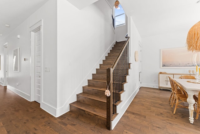 staircase featuring dark wood-type flooring