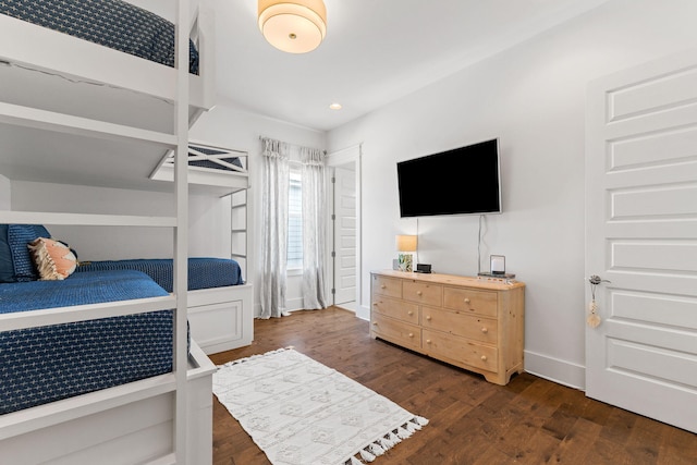 bedroom with dark hardwood / wood-style flooring