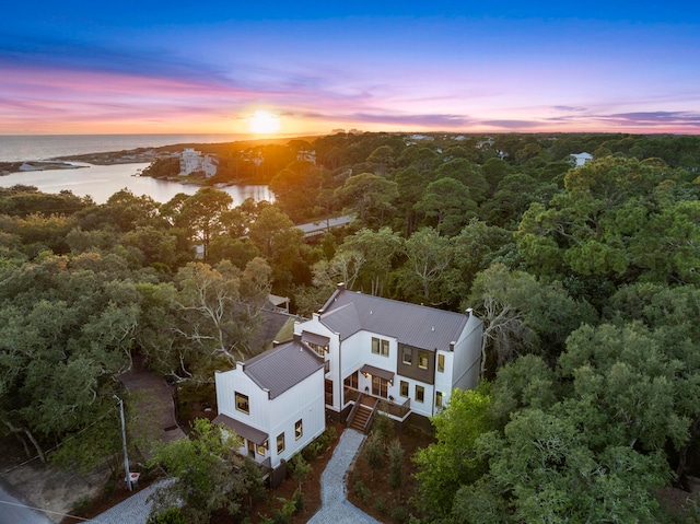 aerial view at dusk with a water view