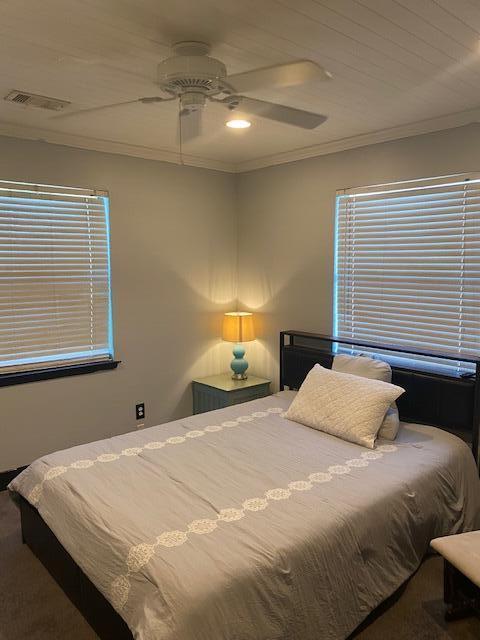 carpeted bedroom with ceiling fan