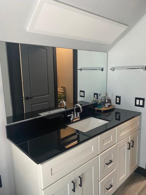 bathroom with hardwood / wood-style flooring and vanity