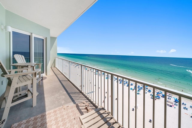balcony with a beach view and a water view