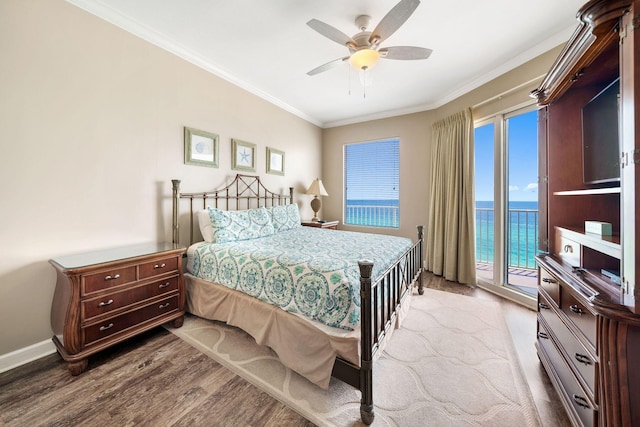 bedroom featuring wood finished floors, a water view, access to exterior, ceiling fan, and ornamental molding