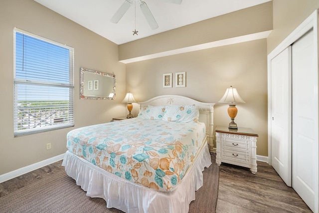 bedroom featuring a closet, ceiling fan, wood finished floors, and baseboards