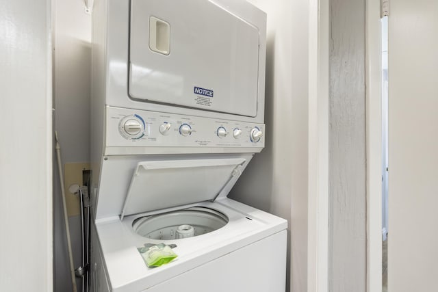 laundry area with stacked washer and dryer and laundry area